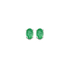 oval prong set emerald studs in 14k white gold